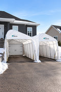 Two Harnois Monopente car shelters installed side by side against a house in winter